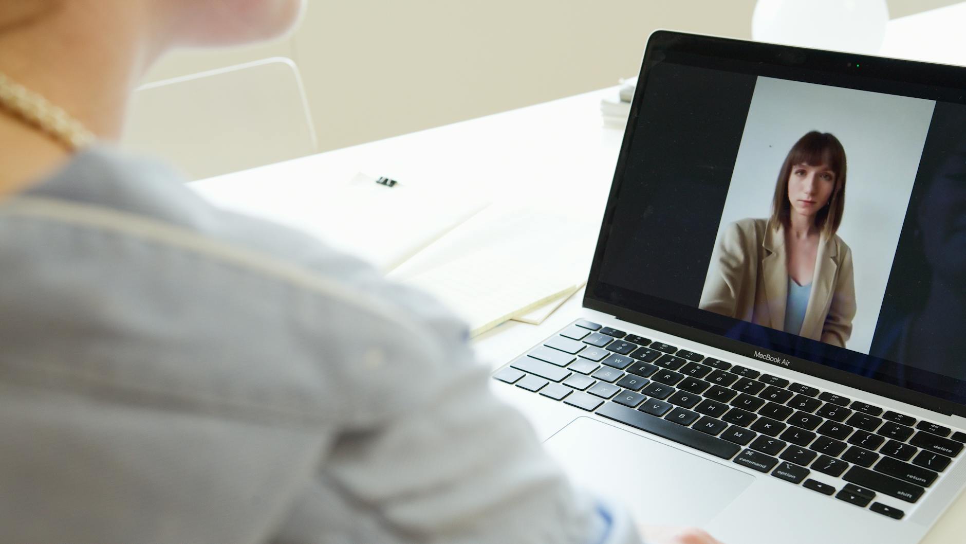 photo of a woman on the screen of a laptop